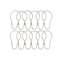 Twelve satin silver pear shaped rings laid out in two rows of six