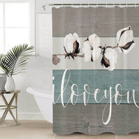 Branch of white cotton flowers on horizontal taupe and beige wood planks