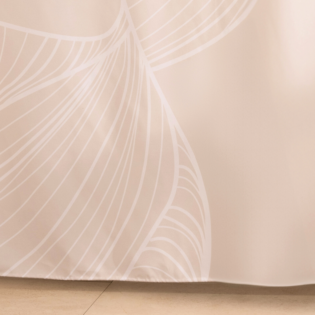 Full length ivory curtain hanging beside a glass shower screen