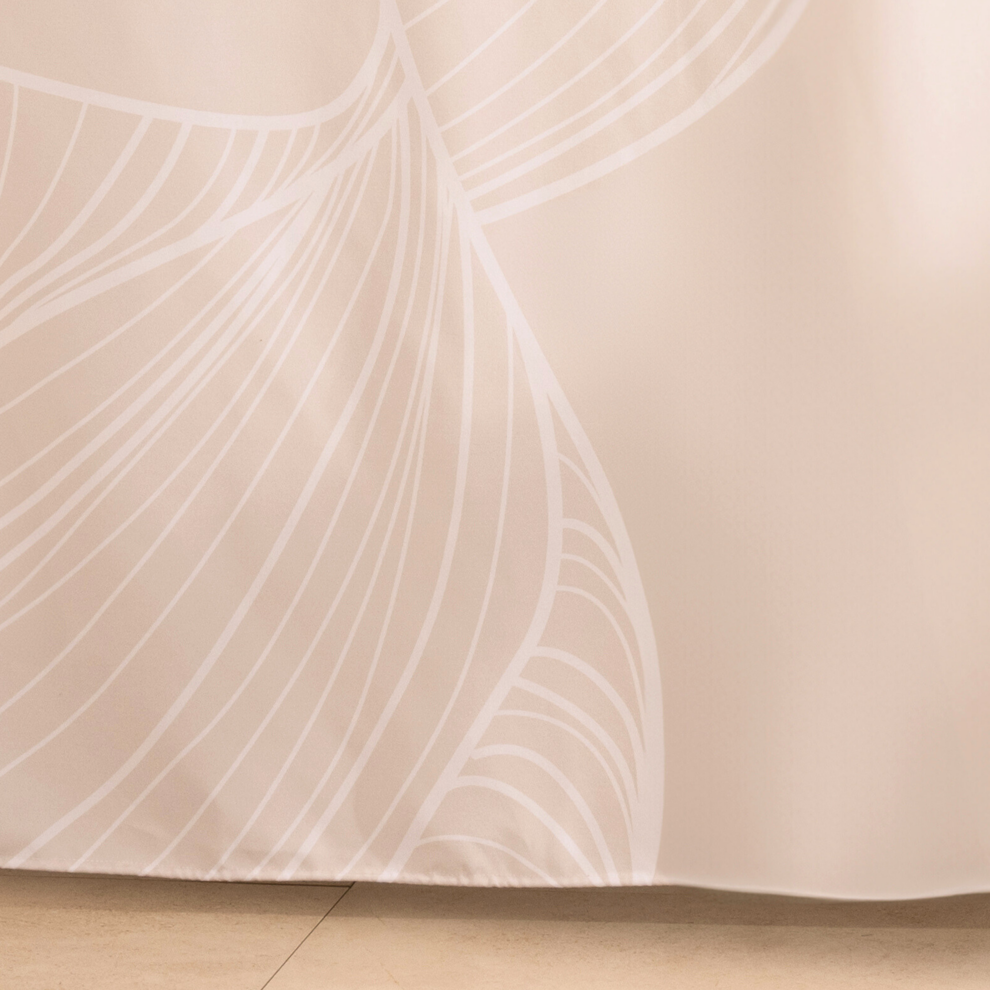 Full length ivory curtain hanging beside a glass shower screen