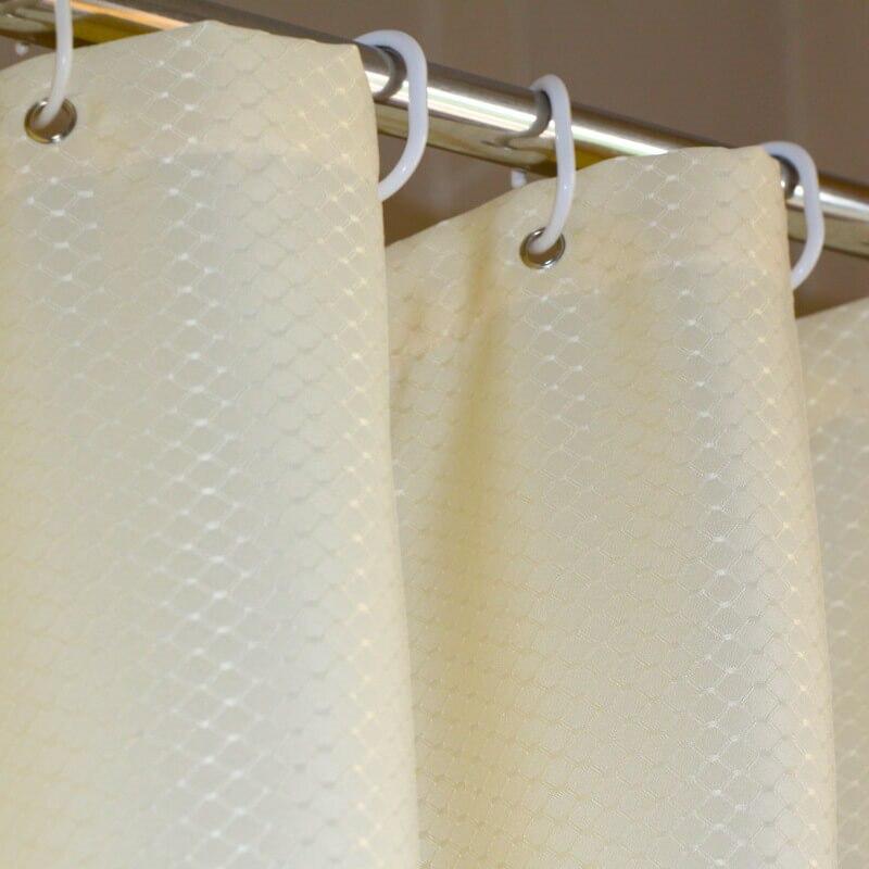 Macro inset showing water droplets beading on the ivory woven fabric
