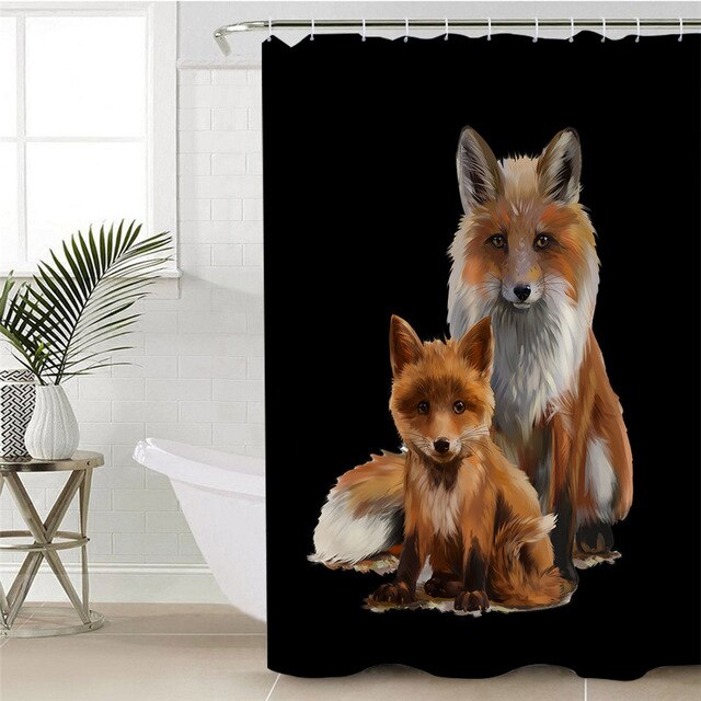 Two red foxes standing out against a deep black background