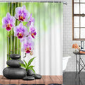 Mauve orchids and bamboo stems against a blurred green background