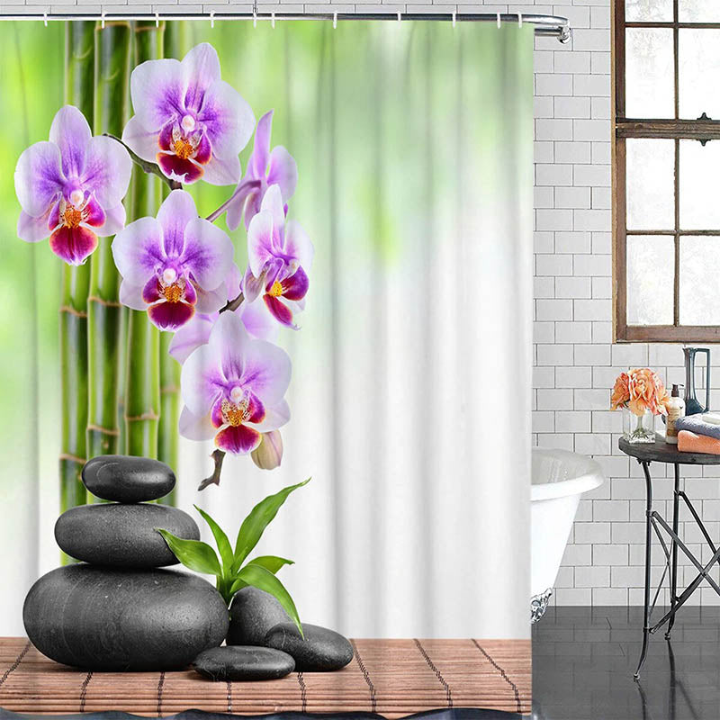 Mauve orchids and bamboo stems against a blurred green background