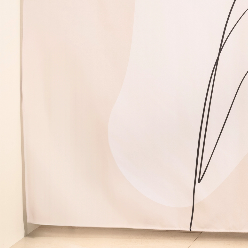 Full length greige line art curtain hanging beside a bathtub