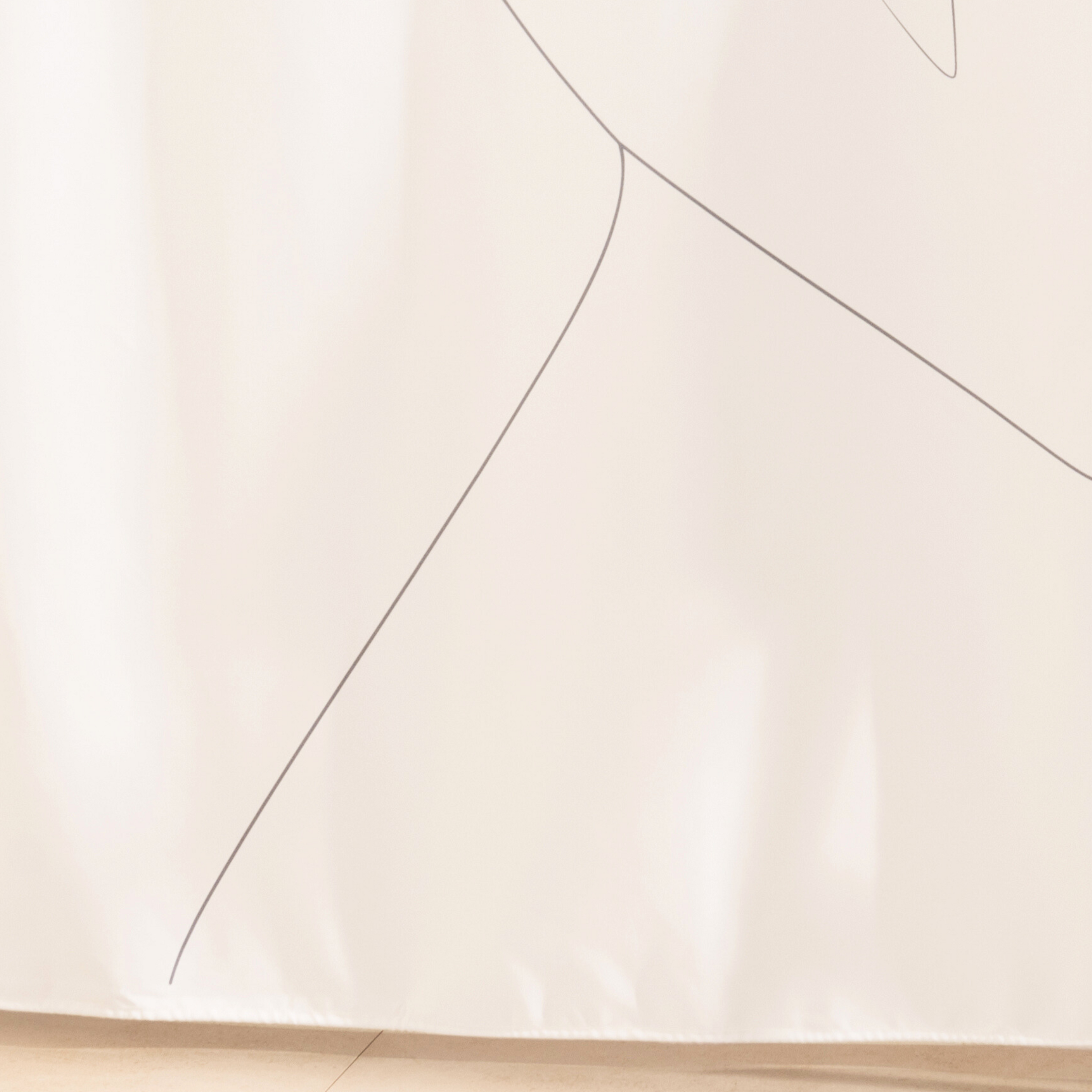 Full length line figure curtain hanging beside a glass screen