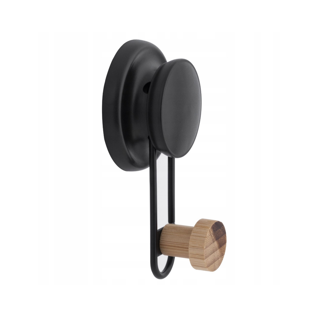 Black bamboo tipped hook holding a folded towel against the wall