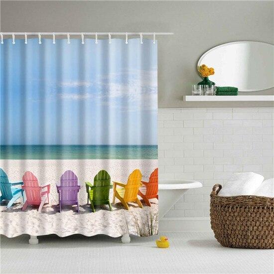 Row of multicoloured deck chairs on pale sand beside a turquoise sea