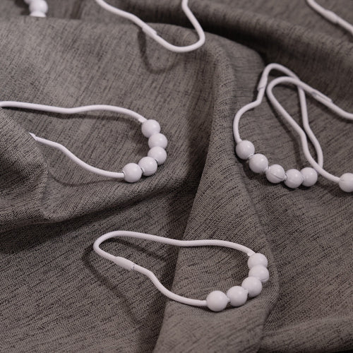 Close view of the white bead crown on a single curtain ring