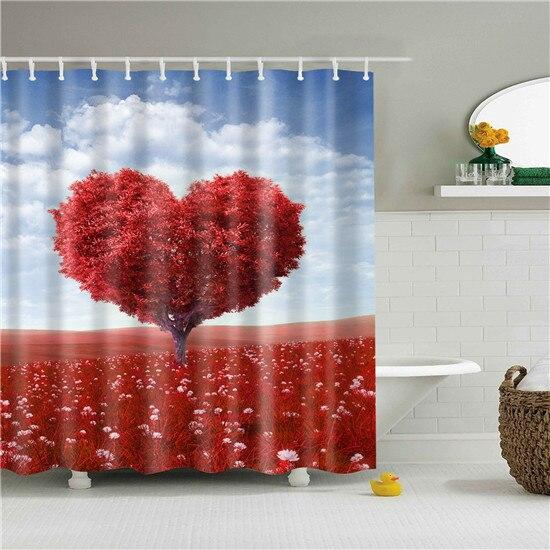 Heart shaped tree with red foliage above a field of red flowers