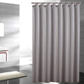Plain grey woven curtain panel falling in soft natural textile folds