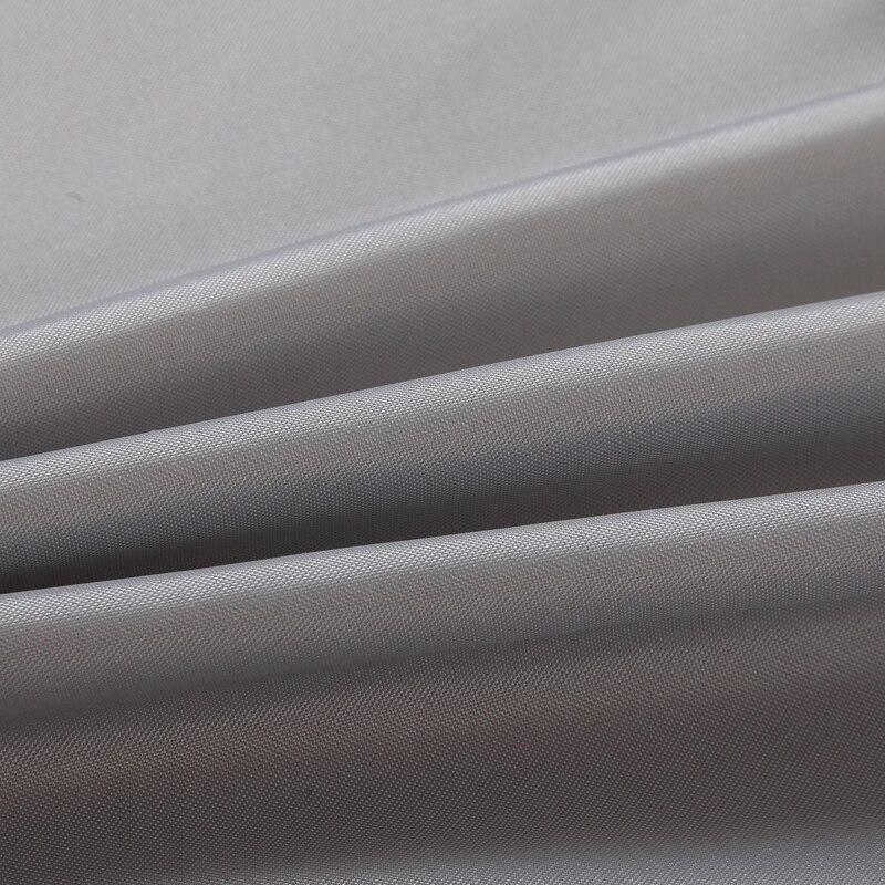 Grey woven curtain styled in a calm neutral bathroom setting