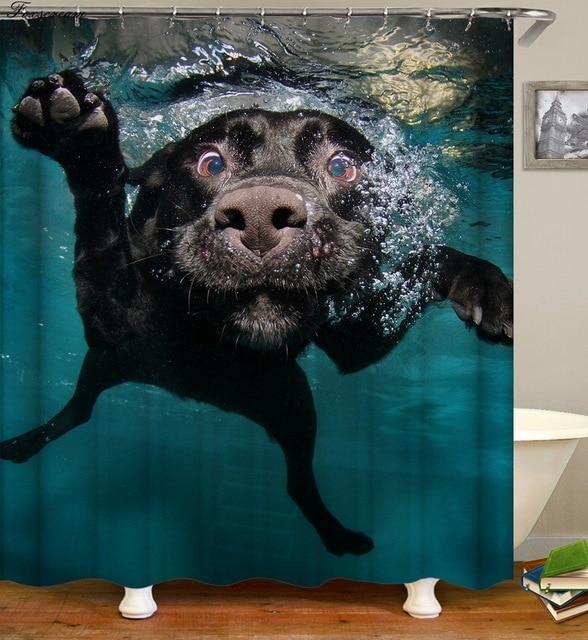 Black labrador seen close up against petrol blue water traced with rising bubbles