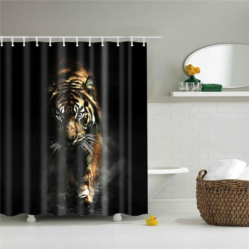 Tawny brown tiger walking across the centre of a solid black background