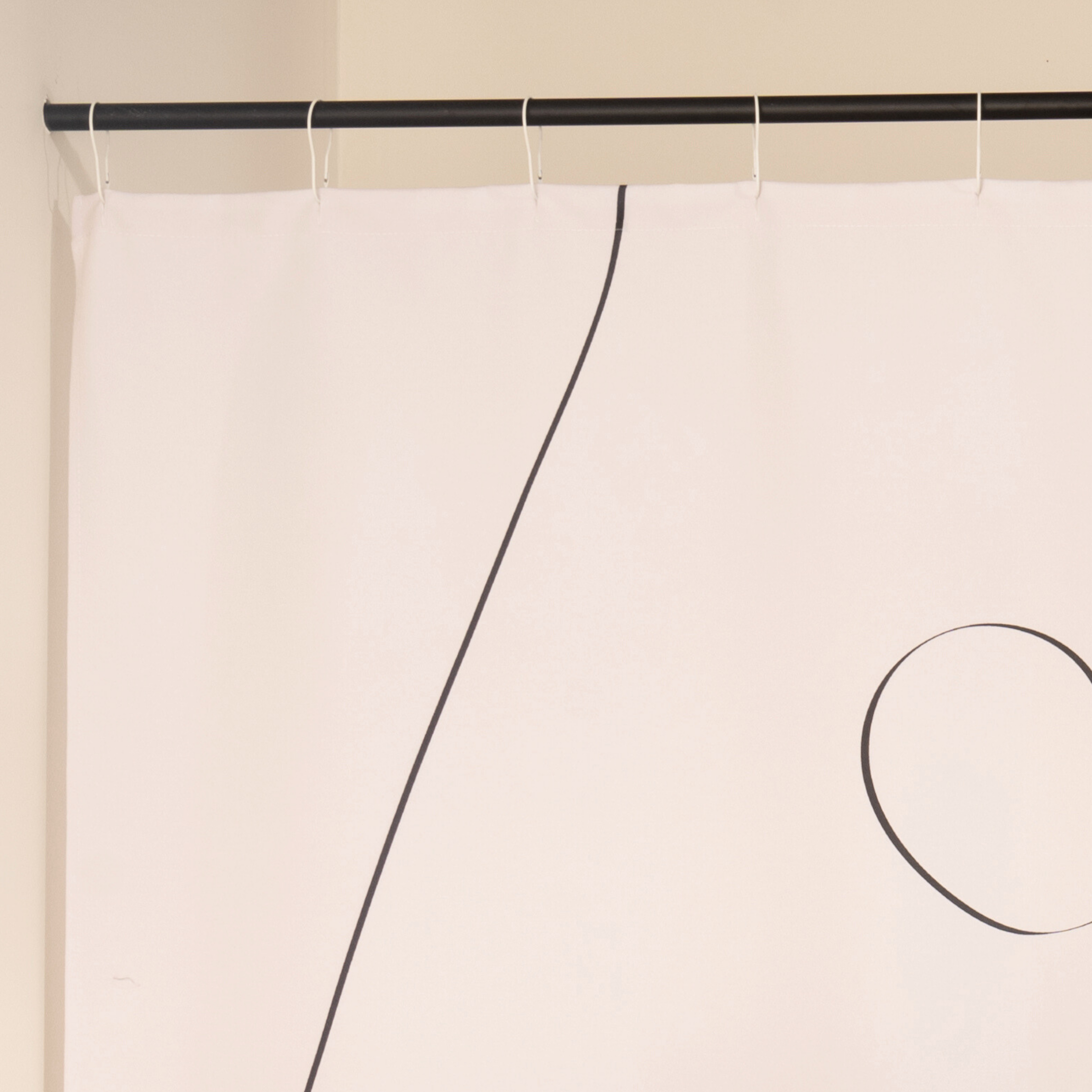 Close detail of the free looping line drawn across the cream cloth