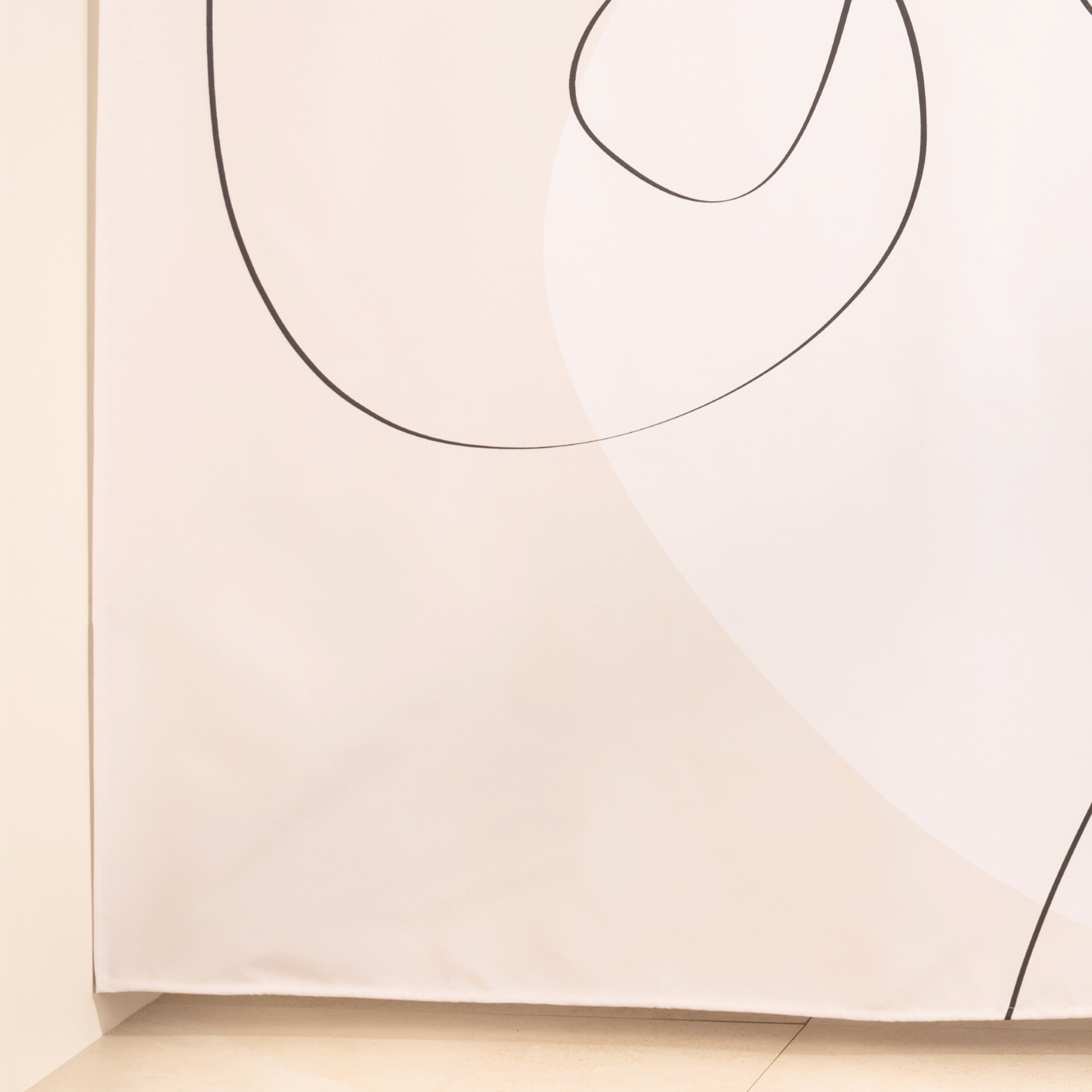 Full length abstract line curtain hanging beside a glass screen
