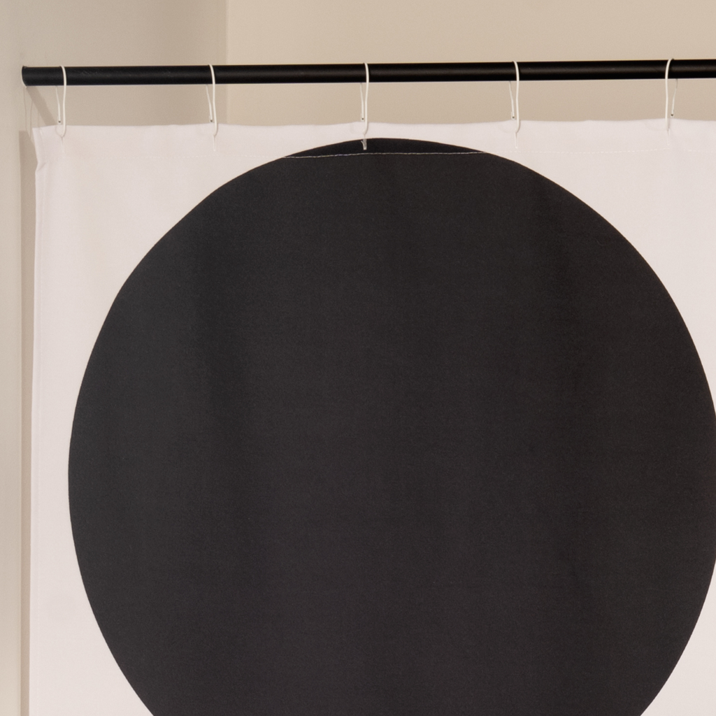 Close detail of the stacked black arcs on the ecru woven ground