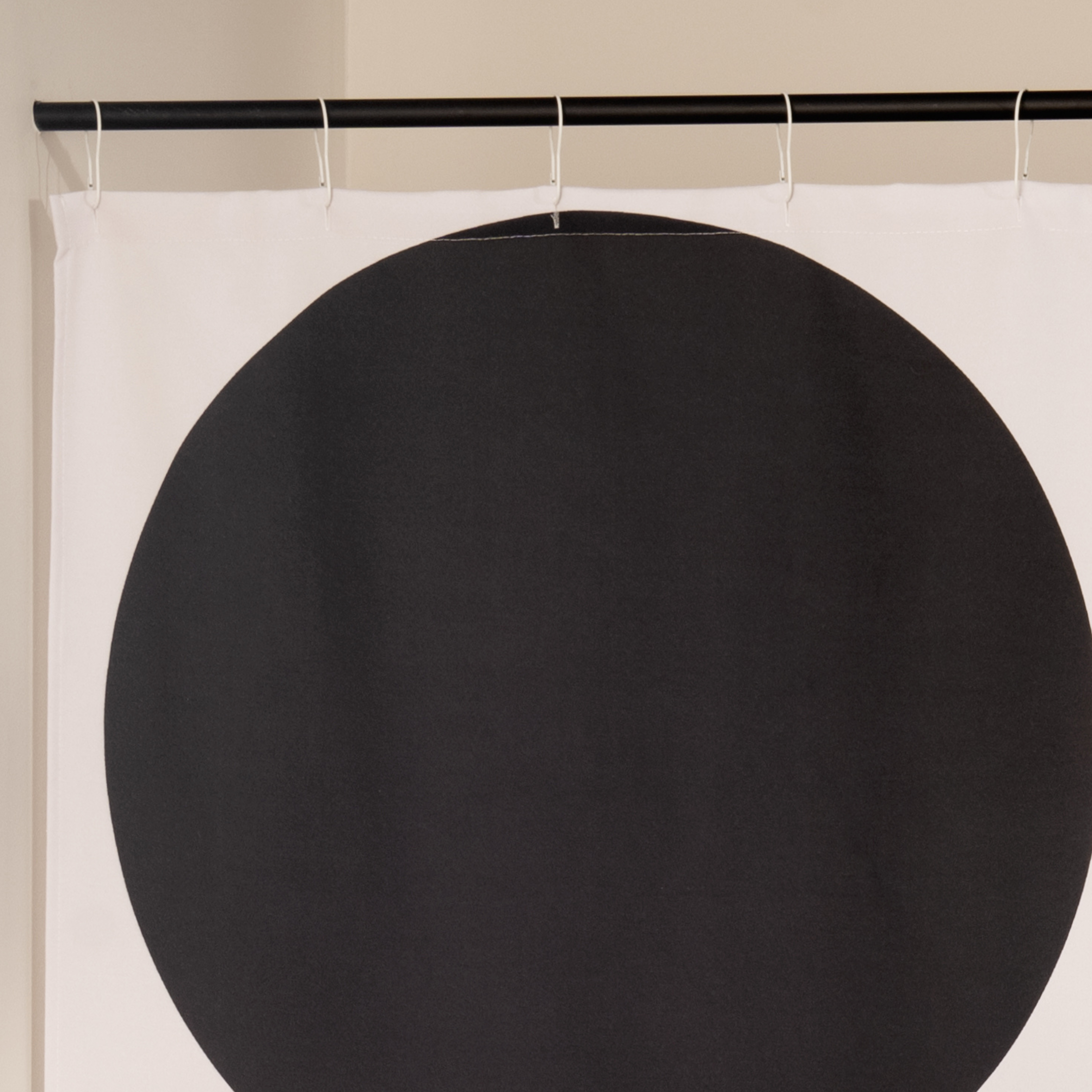 Close detail of the stacked black arcs on the ecru woven ground