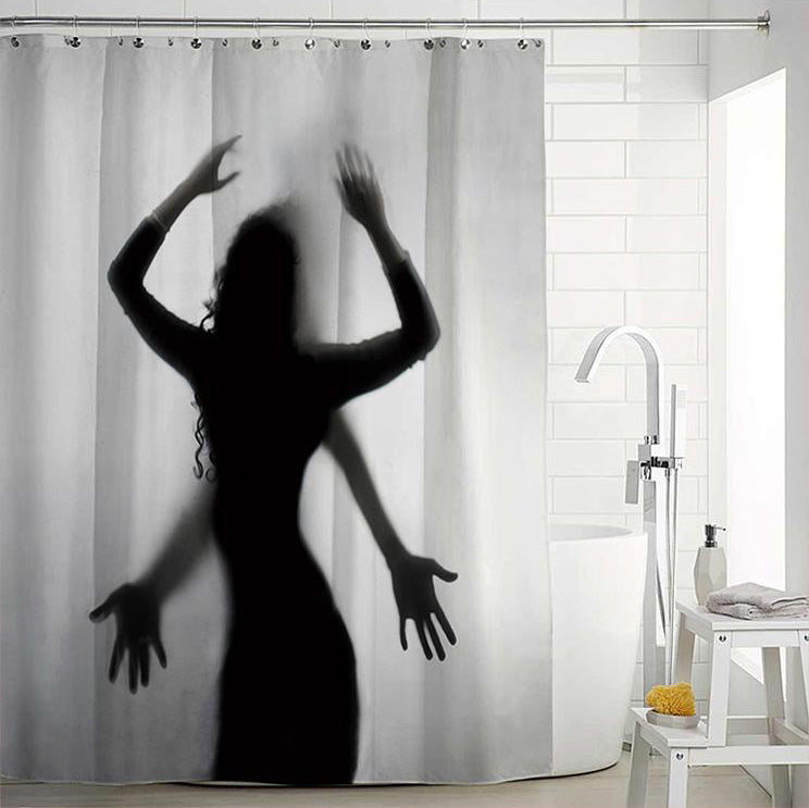 Black backlit female silhouette with open hands pressed against a pale panel