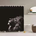 Lion raising its muzzle in profile photographed in black and white on deep black