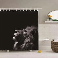 Lion raising its muzzle in profile photographed in black and white on deep black