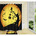 Large golden yellow moon behind a dead tree bats and pumpkins in silhouette
