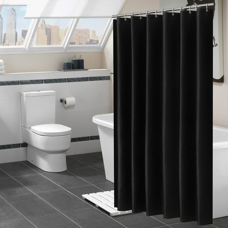 Plain matte black fabric curtain falling in deep even textile folds