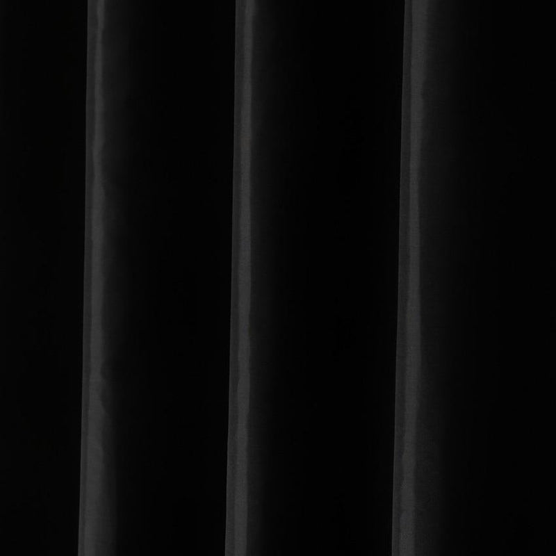 Full length black curtain hanging straight along the edge of a bath