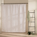 Even scatter of small black dots across a cream beige curtain ground