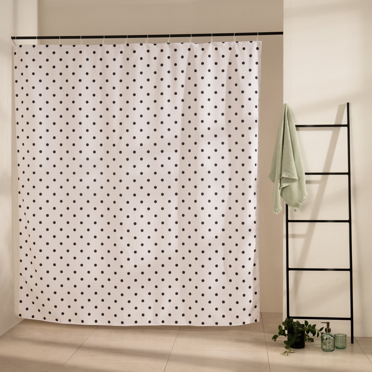 Even scatter of small black dots across a cream beige curtain ground