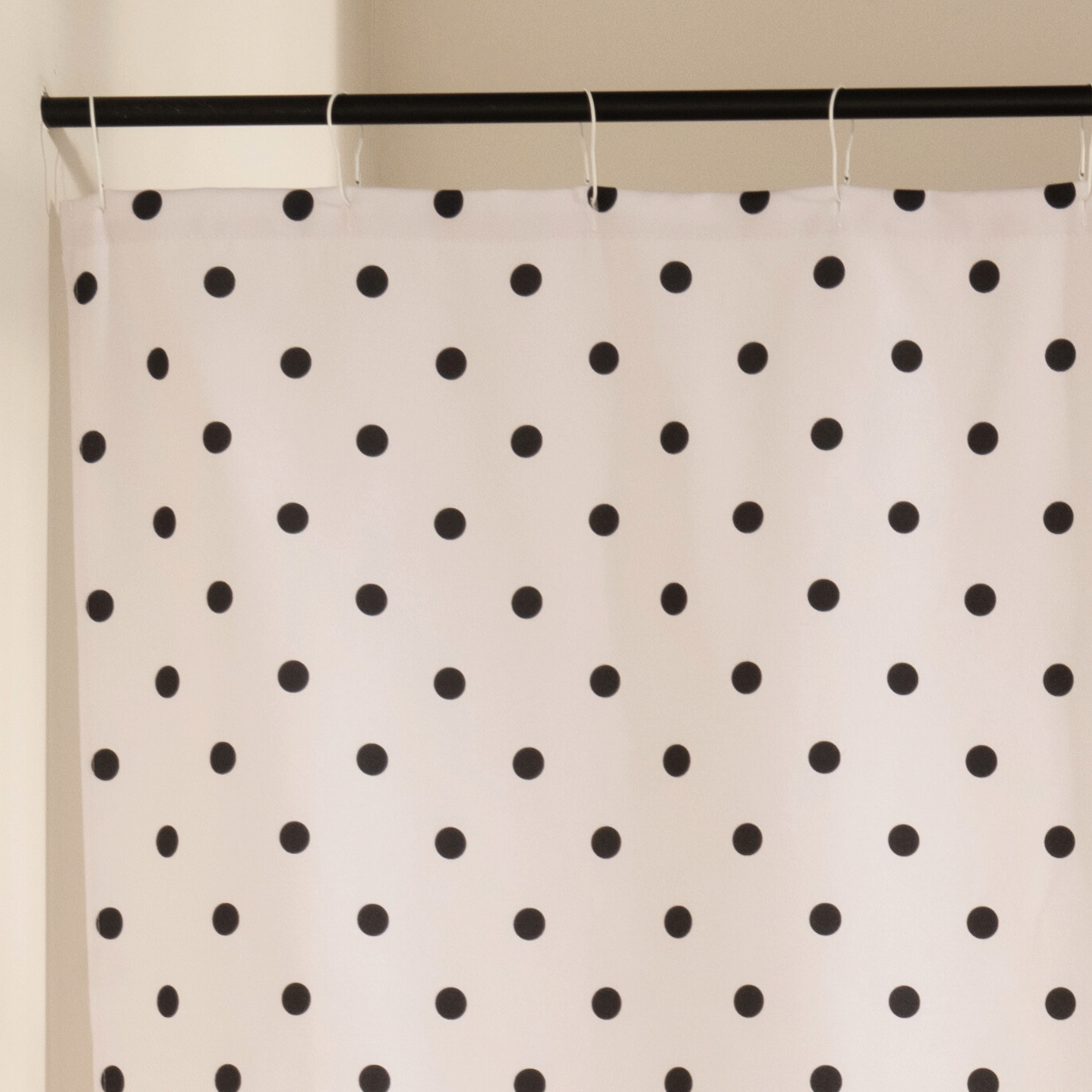 Close detail of the printed black dots on the beige woven cloth