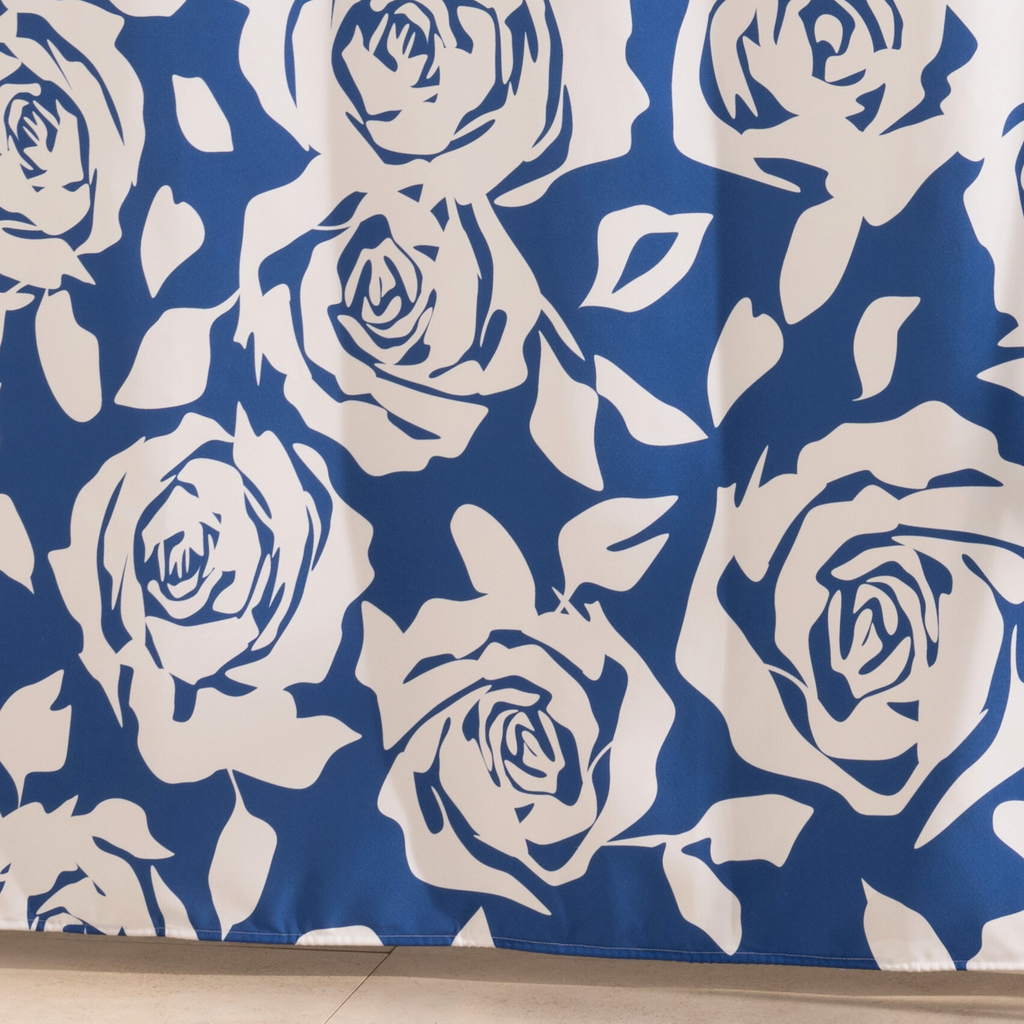Full length navy and cream floral curtain hanging by a glass screen
