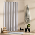 Blue grey vertical stripes on white beside a matching blue towel