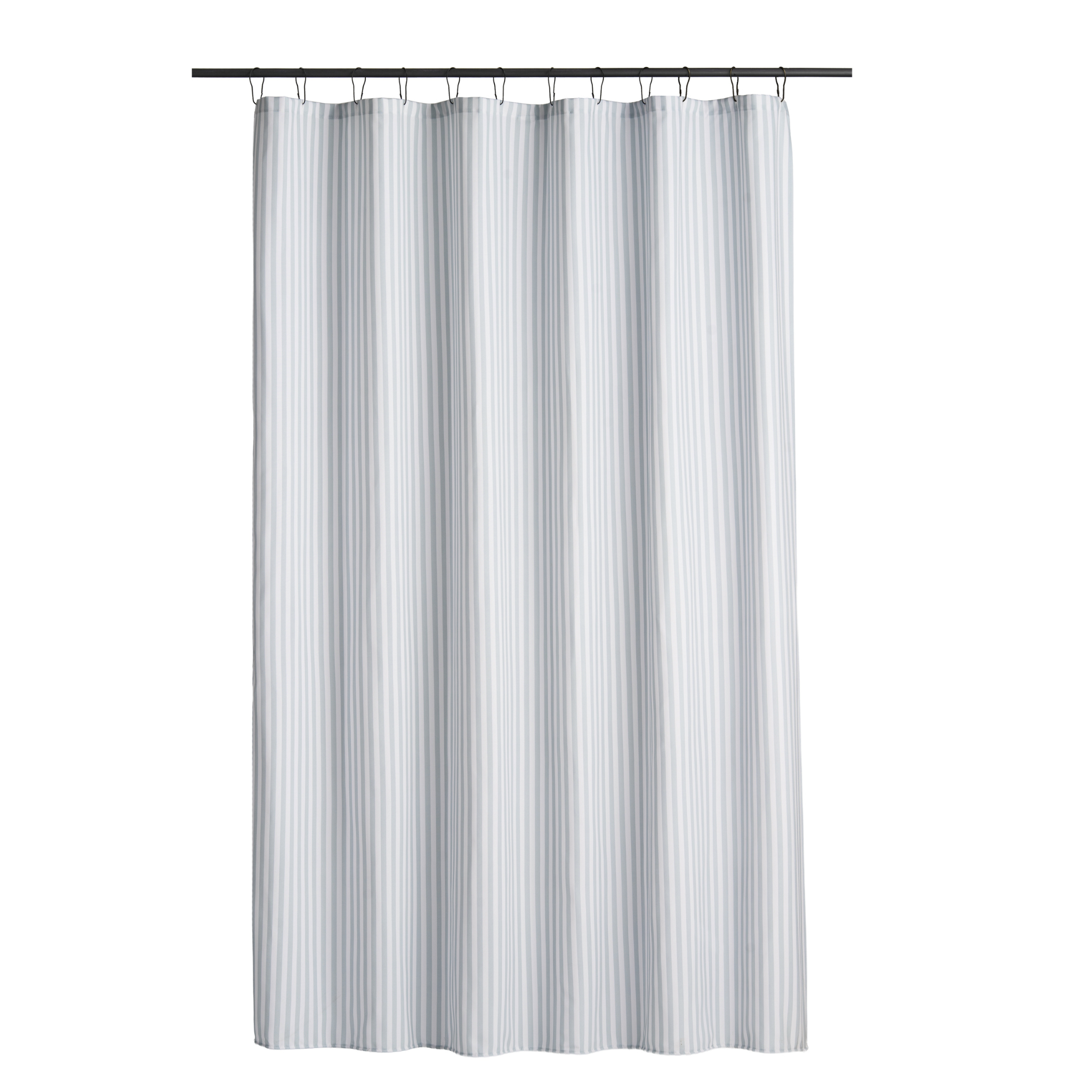 Blue striped curtain styled in a bright bathroom with white tiling