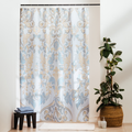 Light blue baroque scrolls and paisley drawn densely on off-white