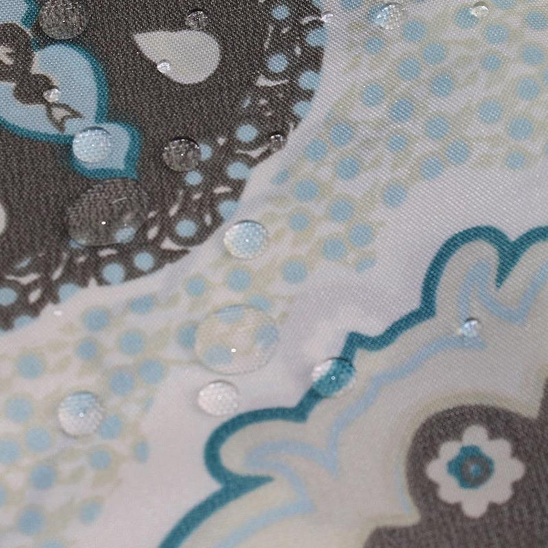 Close view of the burgundy medallion detail on cream fabric