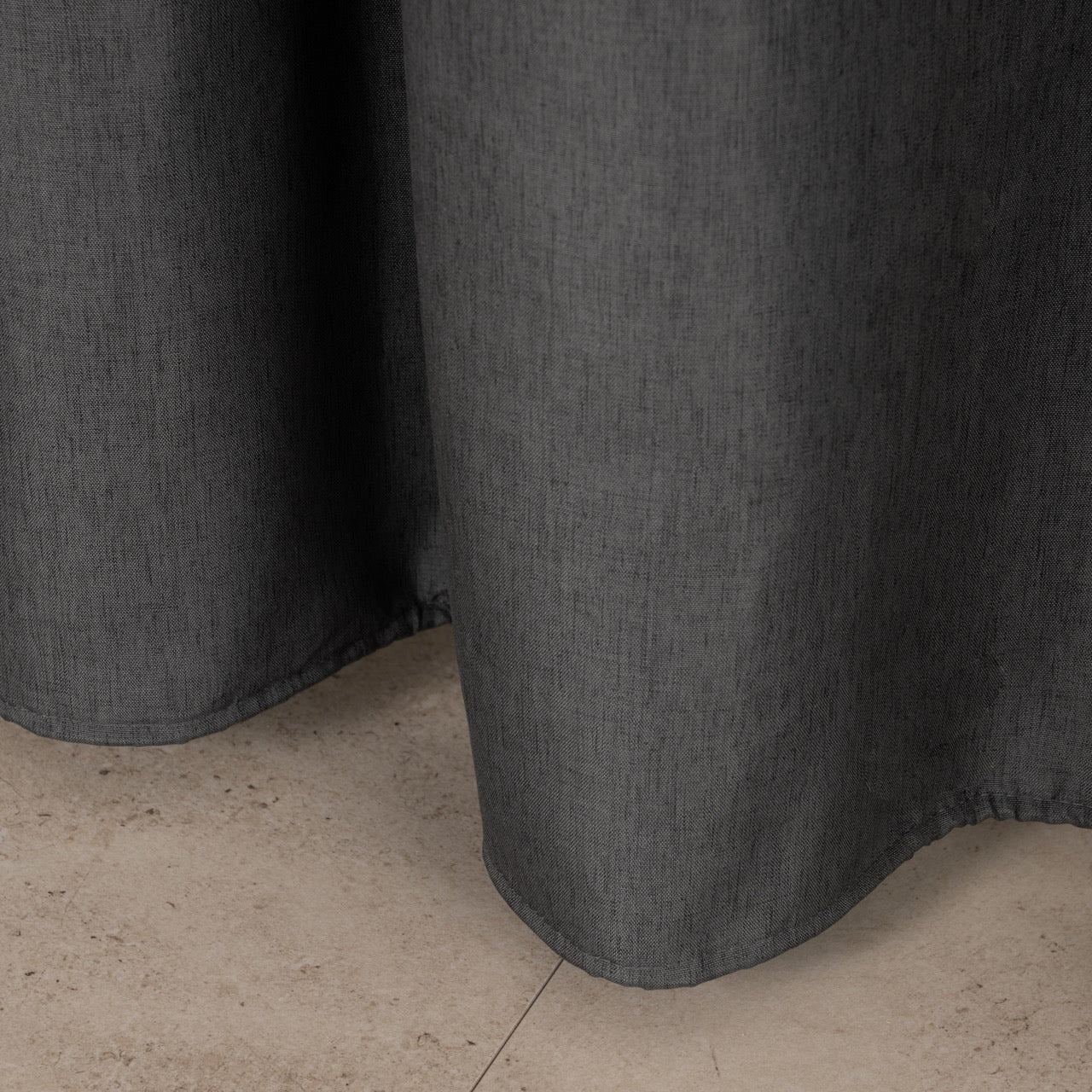 Full length charcoal curtain hanging beside a glass shower screen