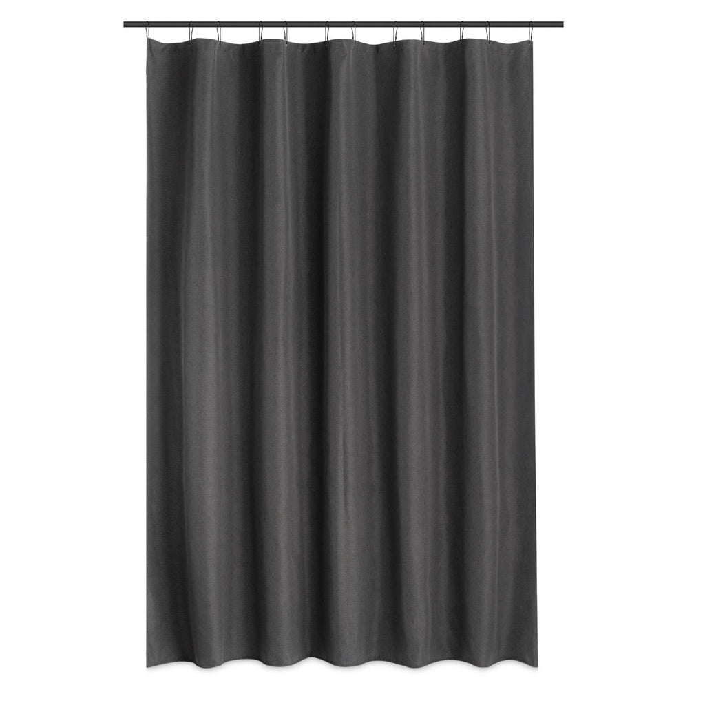 Charcoal curtain styled in a bright bathroom with pale tiled walls