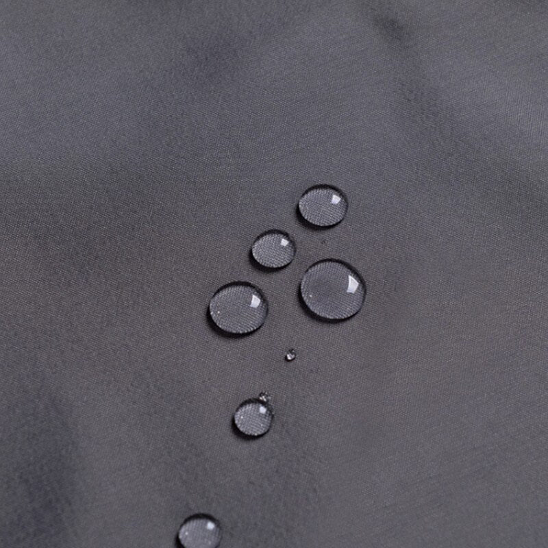 Full length charcoal curtain hanging straight along a white bath