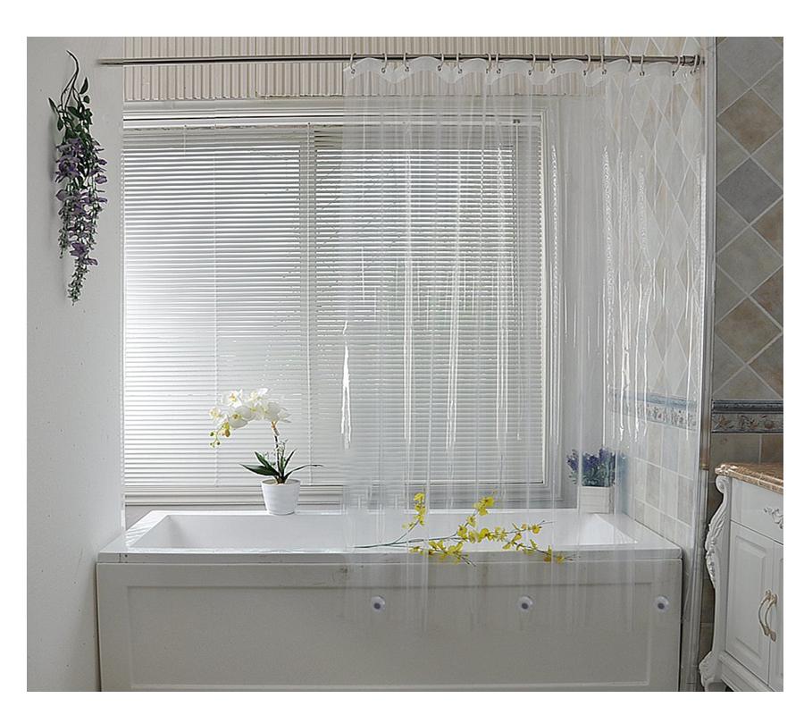 Clear curtain hanging along a bathtub letting daylight into the room