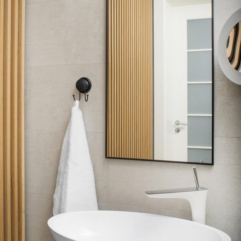 Compact black hook fixed to a glass shower screen without drilling