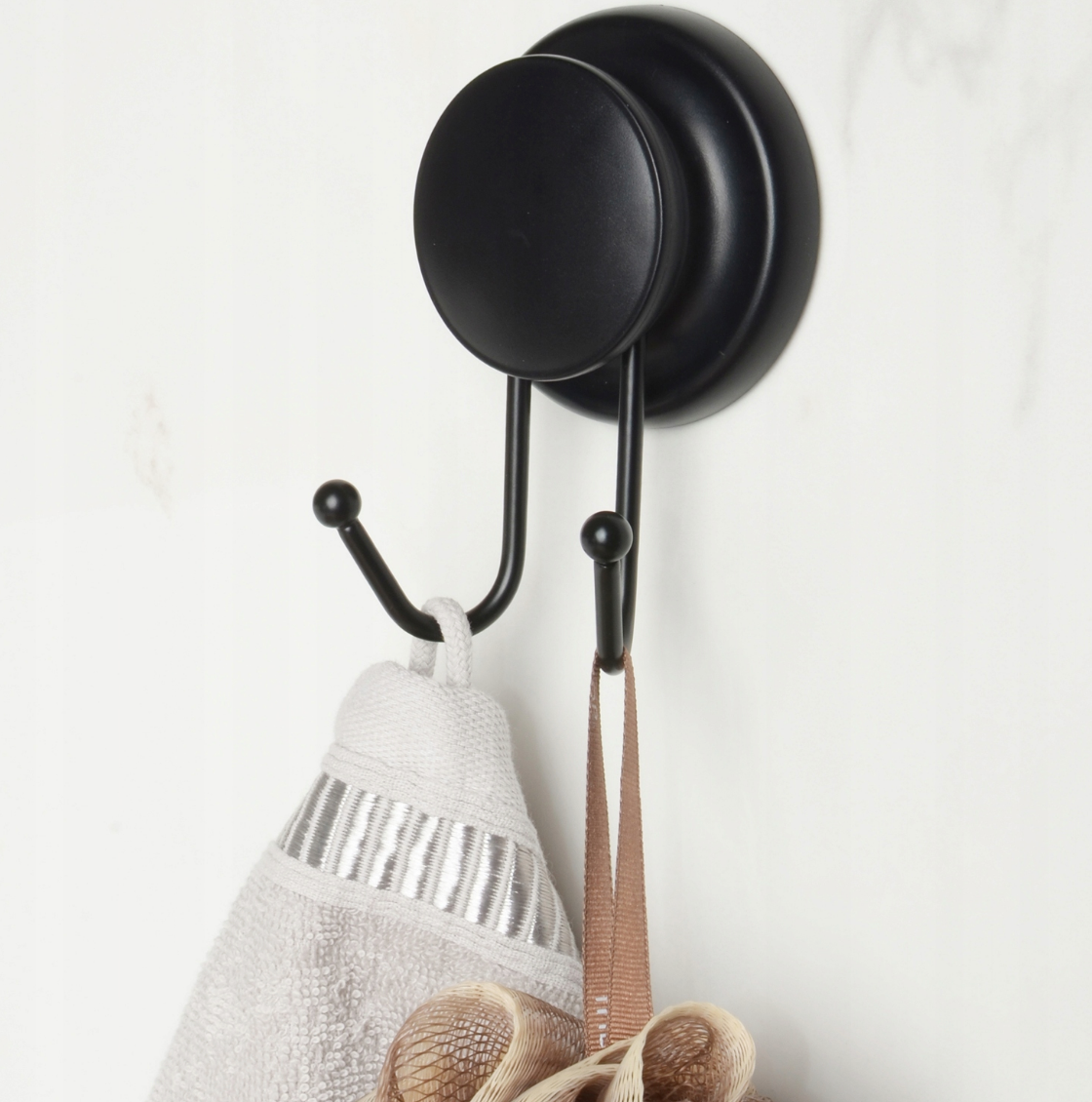 Compact black double hook styled in a small modern bathroom