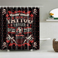Painted tattoo parlor sign with crossed machines and red stars on black