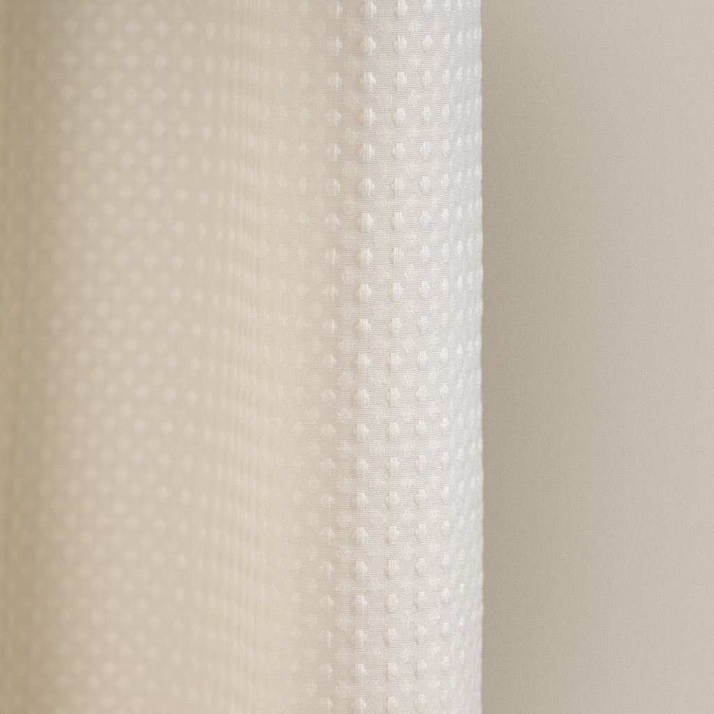 Macro view of the waffle relief across the cream woven surface