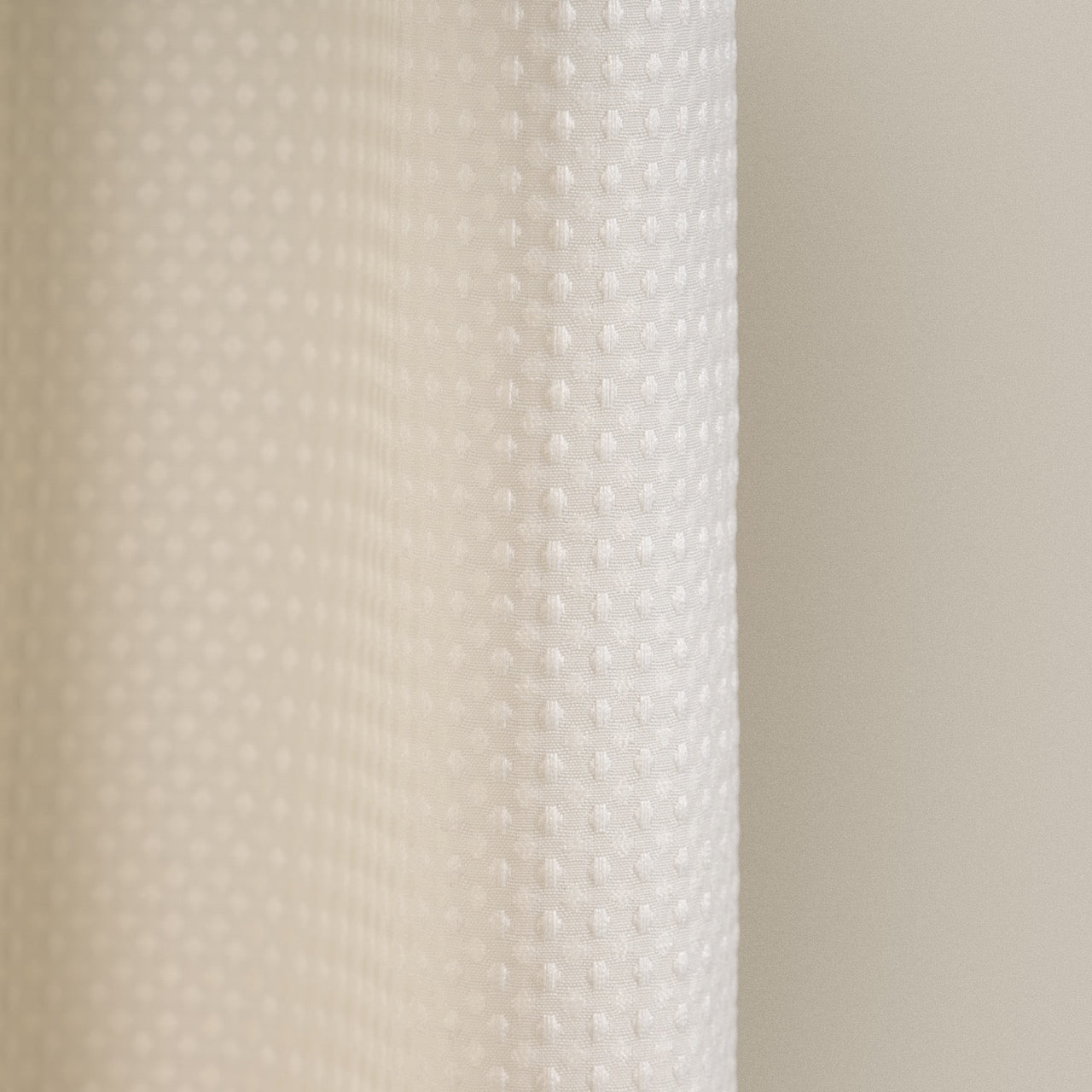 Macro view of the waffle relief across the cream woven surface