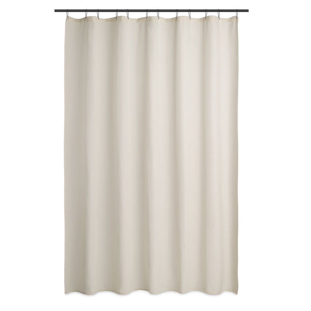 Cream waffle curtain styled in a bright bathroom with pale tiling