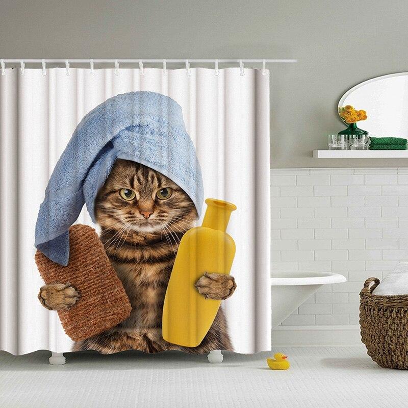 Tabby cat in a blue towel turban holding a hot water bottle and brush