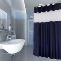 Full length navy and white curtain hanging beside a white bathtub
