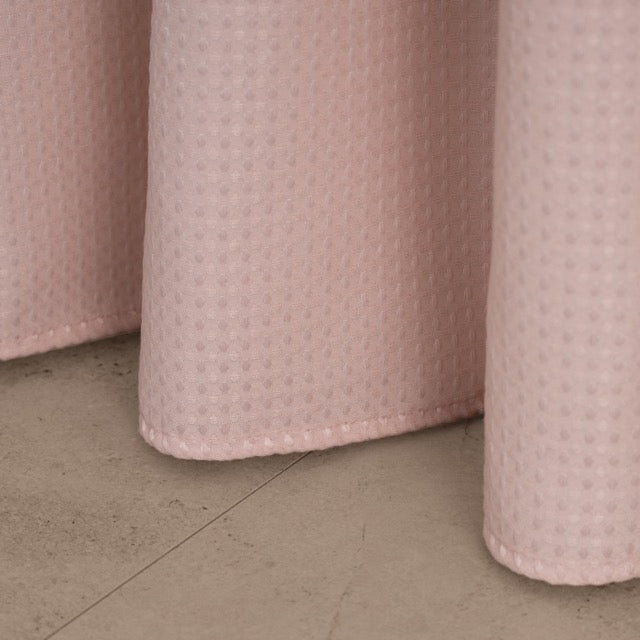 Weighted lower hem holding the dusty rose panel in a straight fall