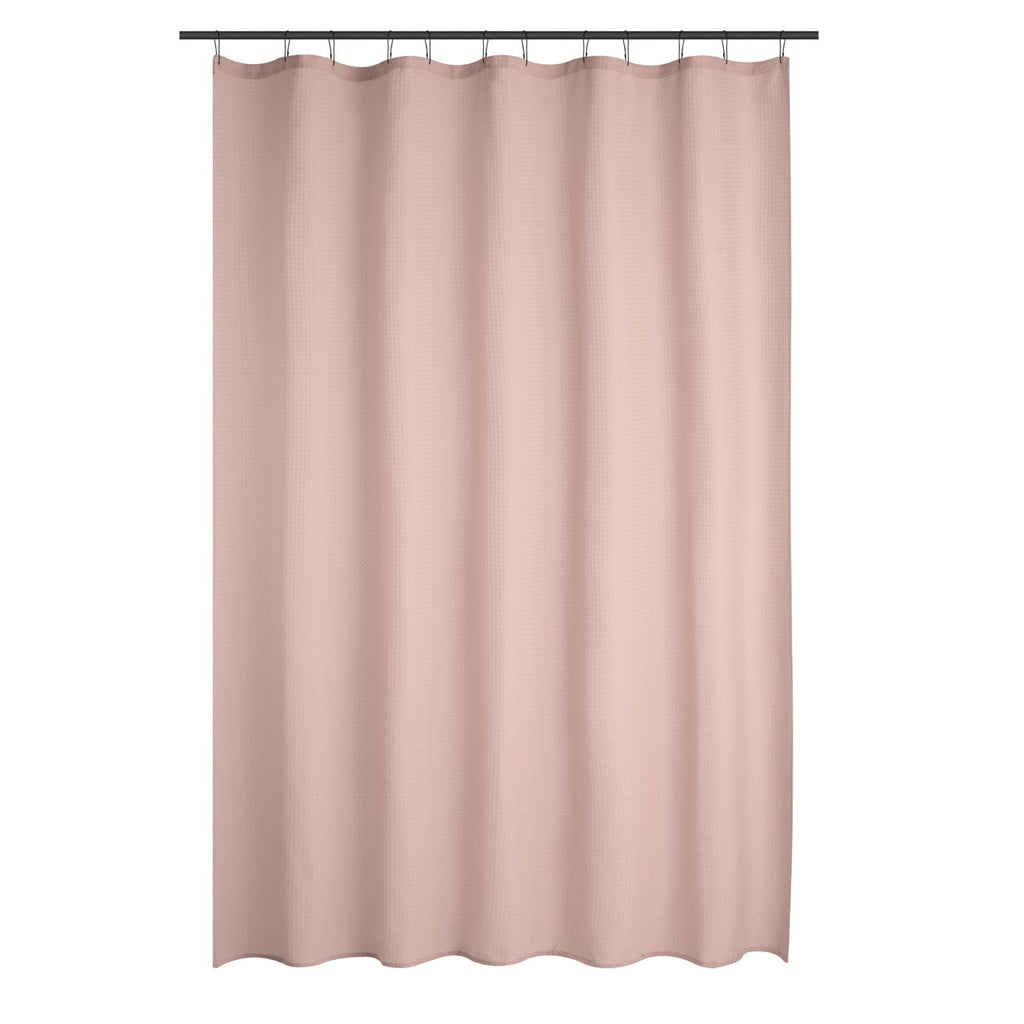 Dusty rose curtain styled in a soft bathroom with pale tiling